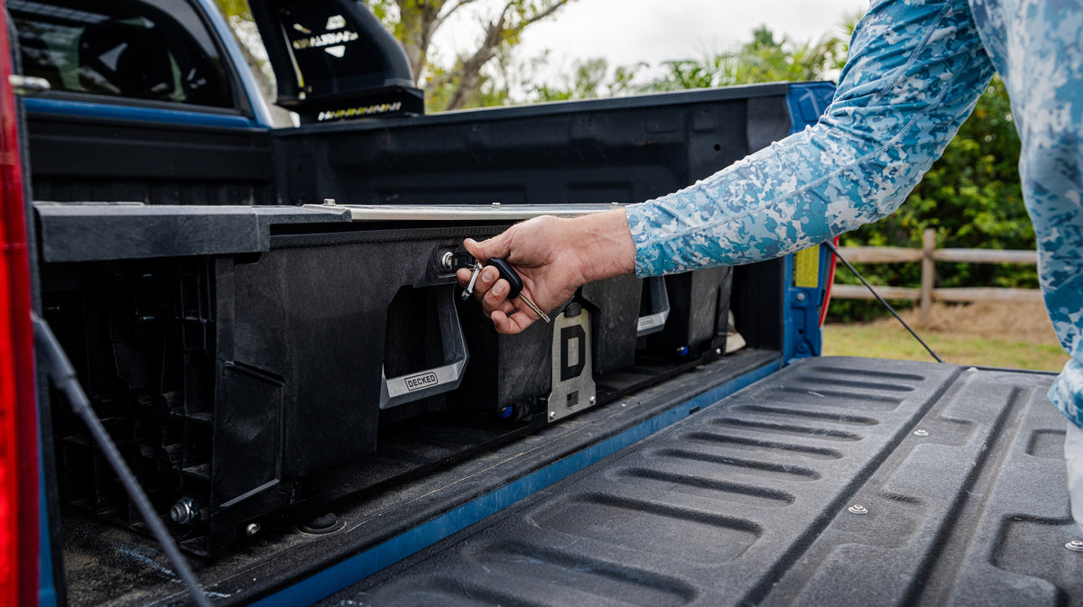 Man locking his DECKED drawer system.