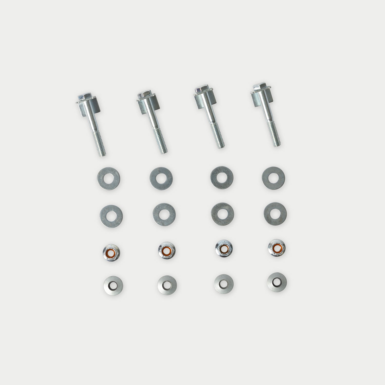 [CGIK-DM] Four silver metal bolts with flat washers and small spring washers arranged in a grid on a light gray background.
