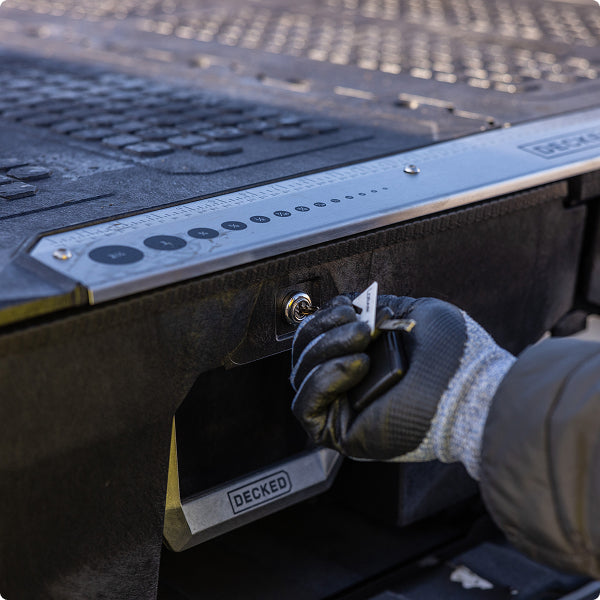 Gloved hand locking DECKED drawer system.