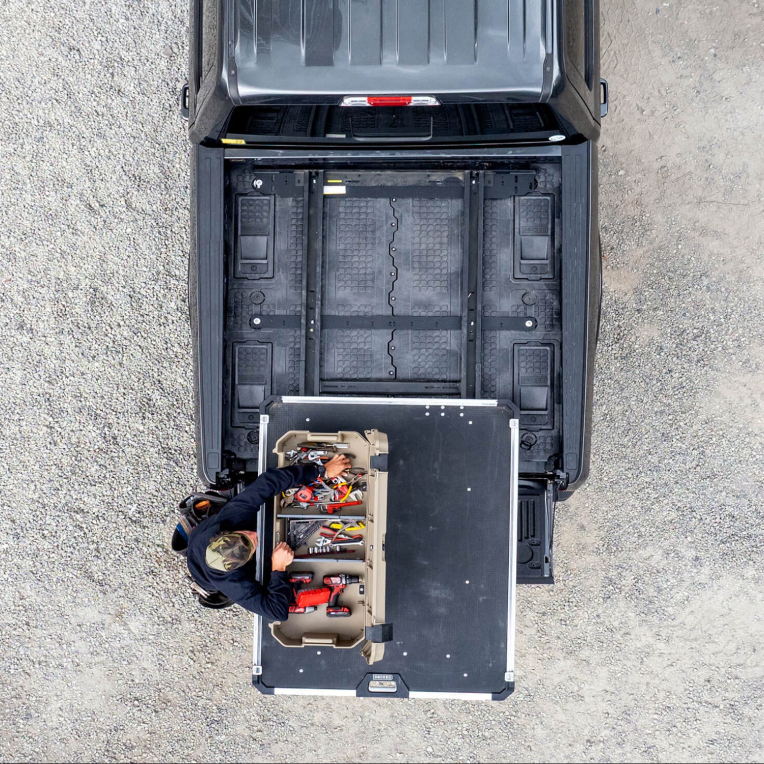 A top down view of a Desert Tan DECKED Honcho D-co case mounted to a CargoGlide that is mounted on a Drawer System. Whoa.
