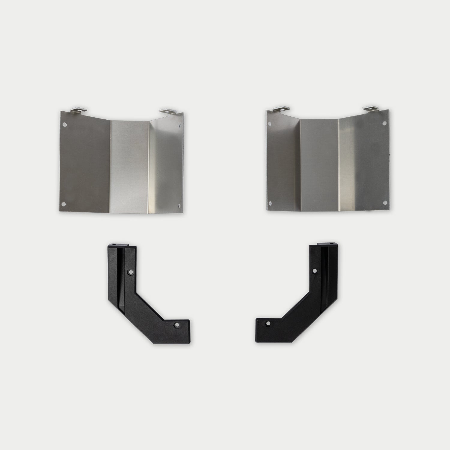 [W-DCG-HS-CORNER-ENDS-KIT] A set of four metal mounting brackets, including two brushed silver rectangular brackets with small tabs and two black L-shaped brackets, arranged on a light gray background.
