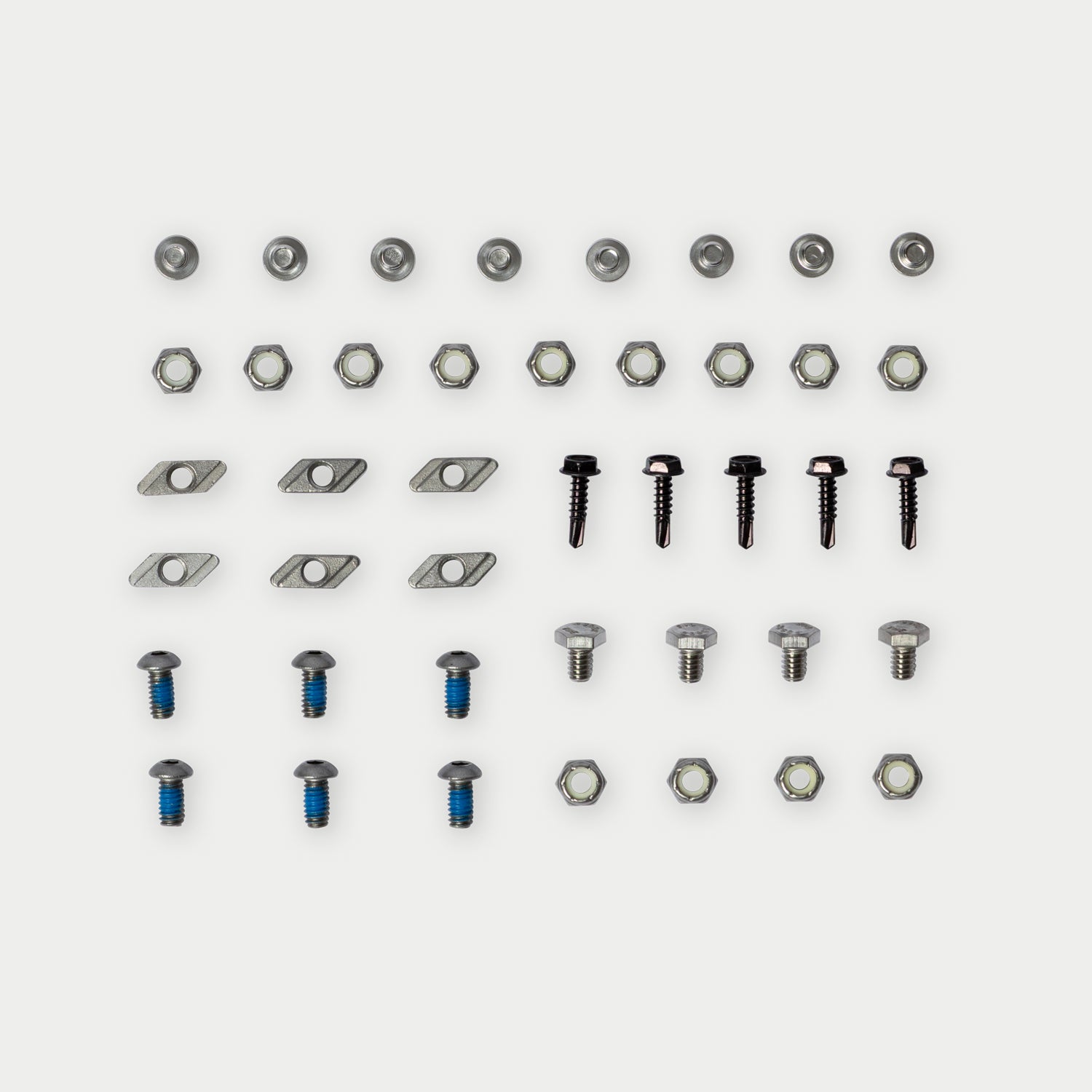 [W-DCG-HS-HW-KIT] A set of small metal hardware components arranged in rows on a light gray background, including screws, nuts, washers, and flat washers.