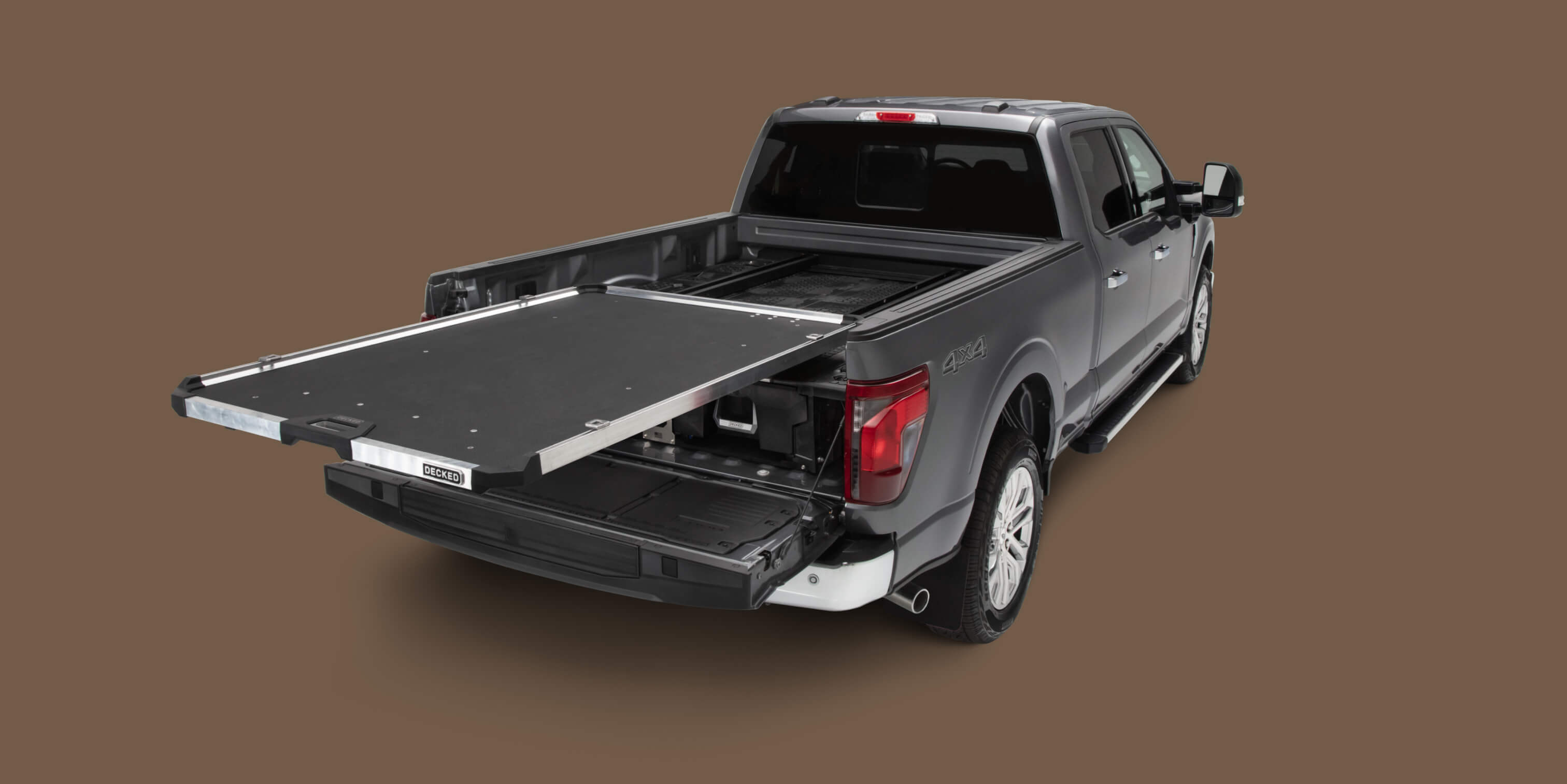 A fully extended CargoGlide mounted on a Drawer System in a full-size truck bed.