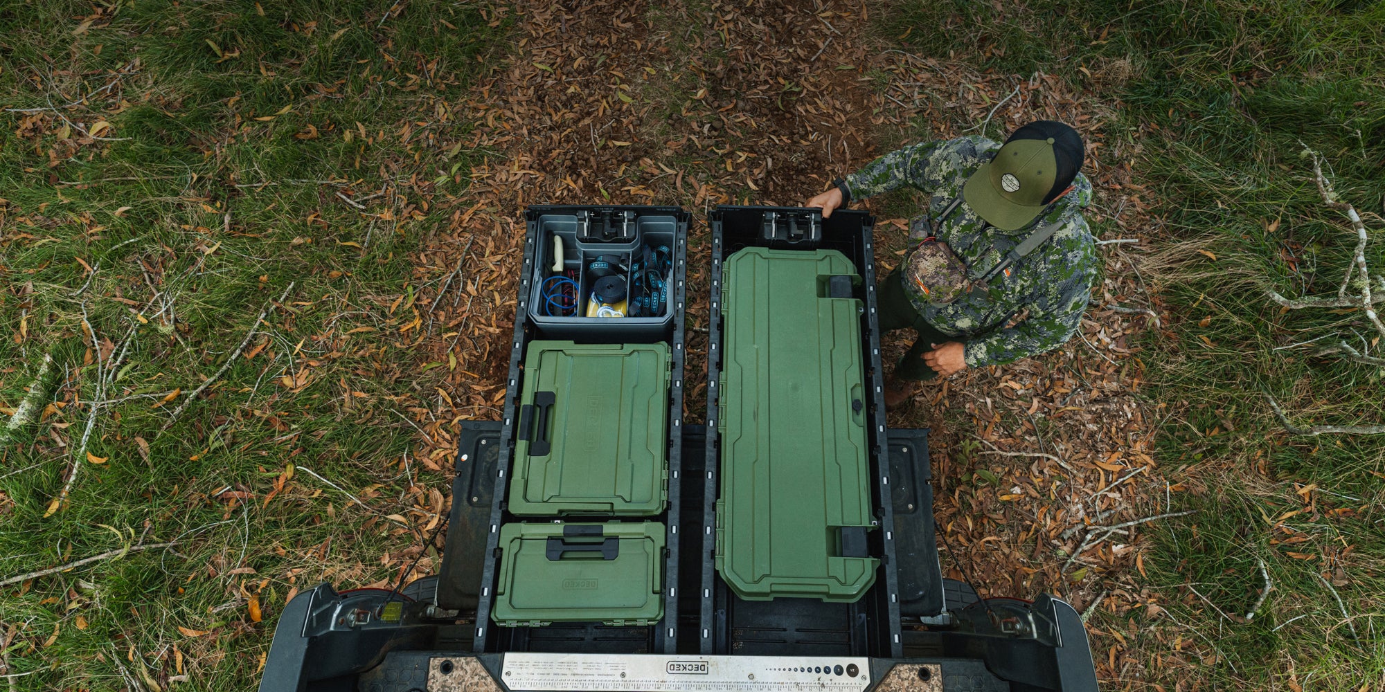 A hunter closing his DECKED Drawer System that is neatly organized with a Ranger Green Honcho, Halfrack and Sixer.