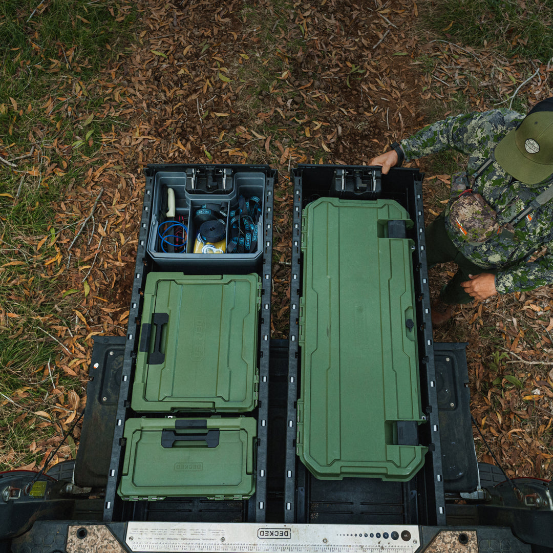 A hunter closing his DECKED Drawer System that is neatly organized with a Ranger Green Honcho, Halfrack and Sixer.