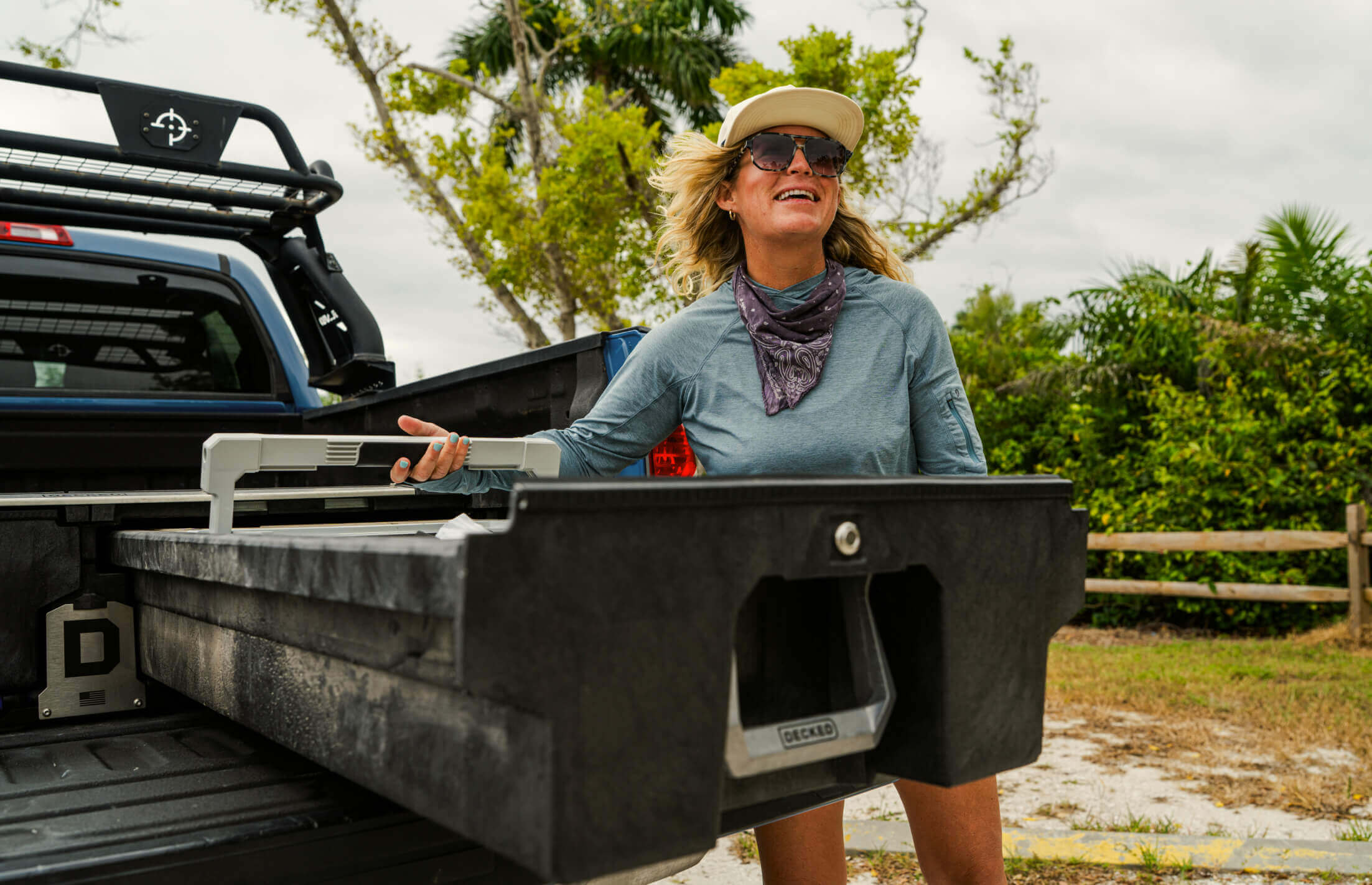 Woman standing in a truck bed with a scenic background