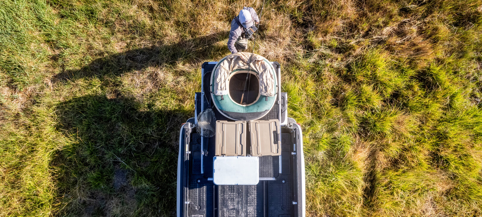 A bird's eye view of a fisherman unloading his float, D-co Cases, and cooler from his CargoGlide.