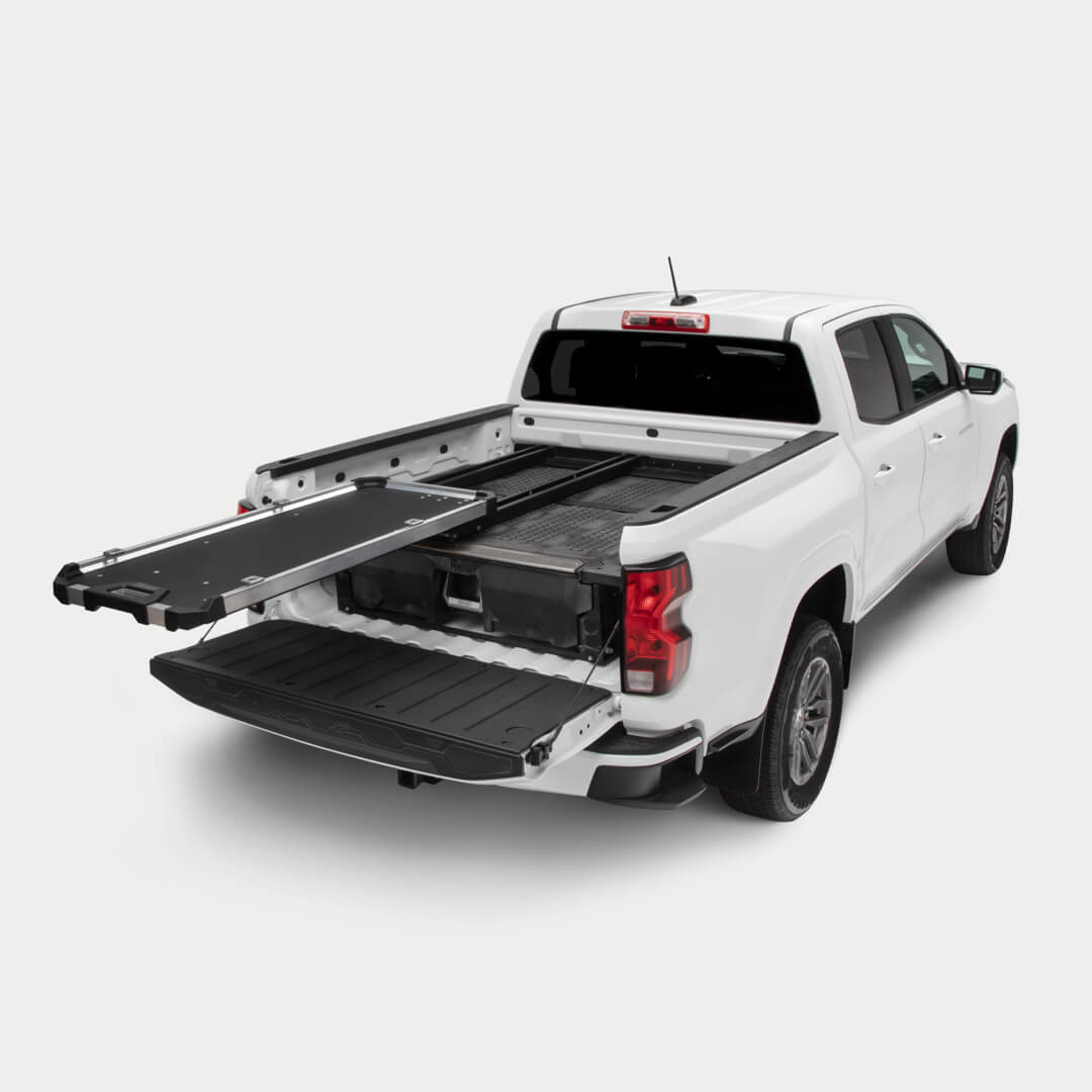 A studio shot of a fully extended CargoGlide 600 mounted on a Drawer System in a midsize truck bed.