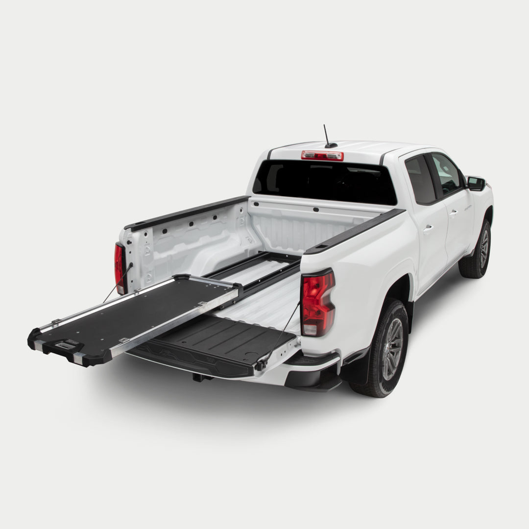 A studio shot of a fully extended CargoGlide 600 mounted on the left side of a midsize truck bed.