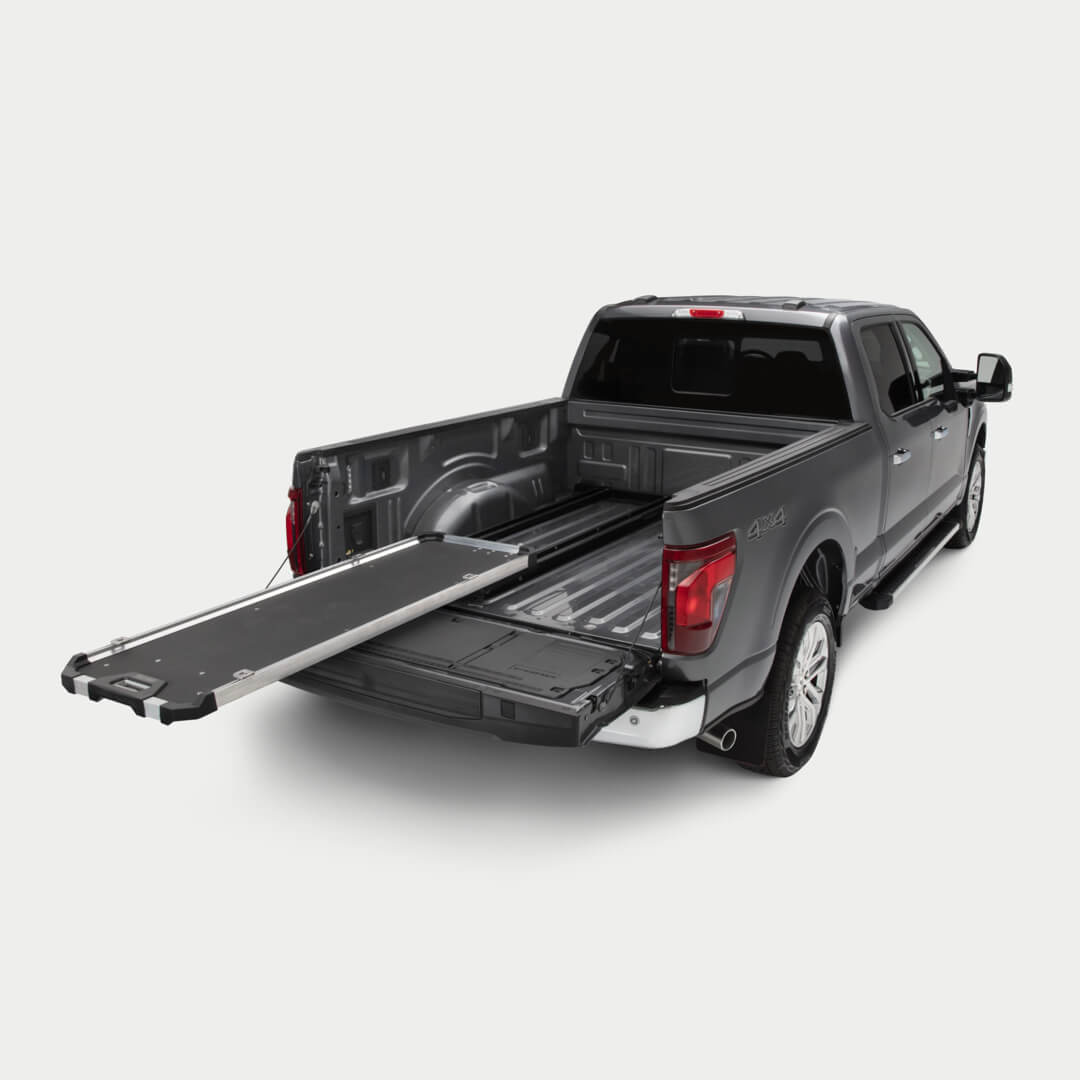 A studio shot of a fully extended CargoGlide 600 mounted on the left side of a full-size truck bed.