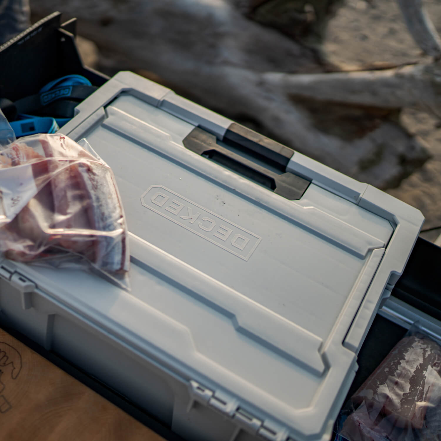 The Cool Gray Halfrack inside of a midsize Drawer System, nearby are newly packaged fish fillets from a day on the water.