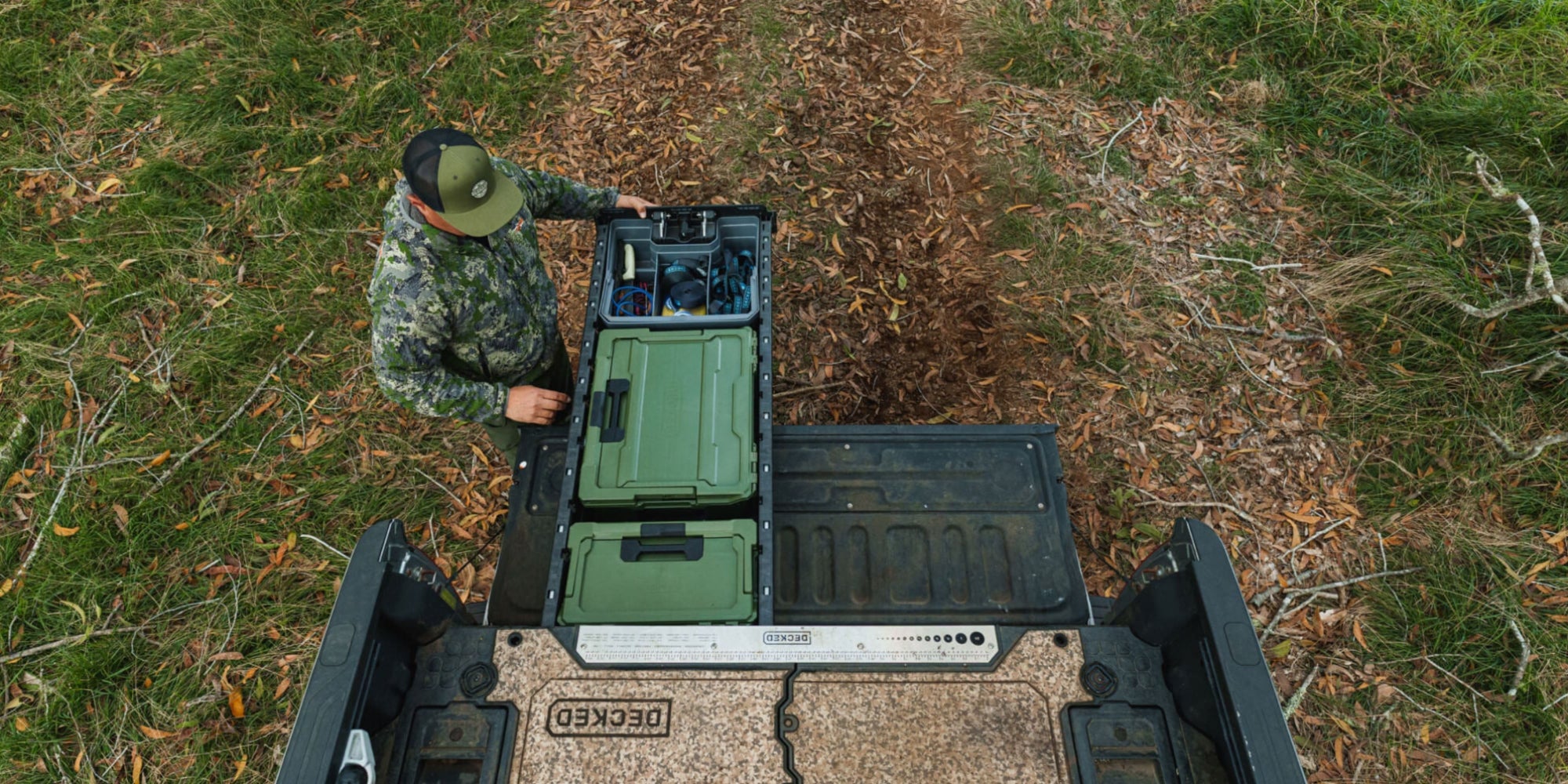 A hunter closing his DECKED Drawer System that is neatly organized with a Ranger Green Halfrack and Sixer.