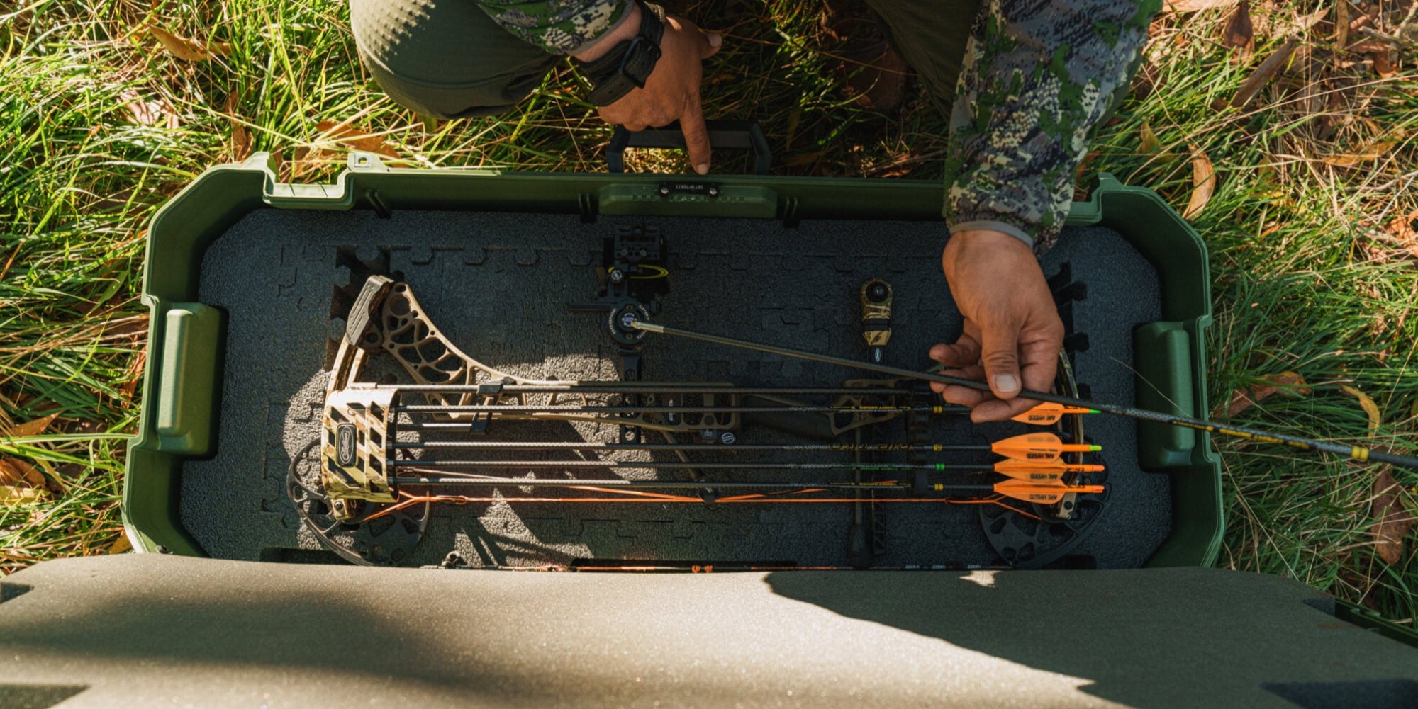 A top view of an open Ranger Green Honcho 80 with a compound bow and arrows stored neatly inside using the Honcho PuzzleFoam.