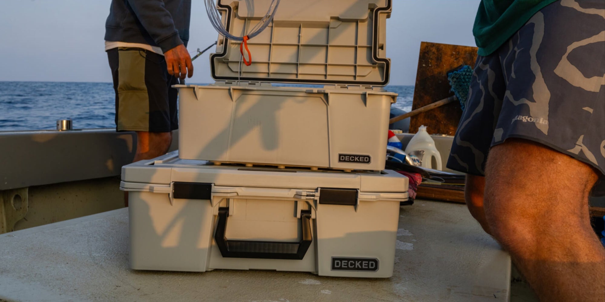 The Cool Gray Sixer, full of fishing supplies, on board of a fishing boat at sunset.