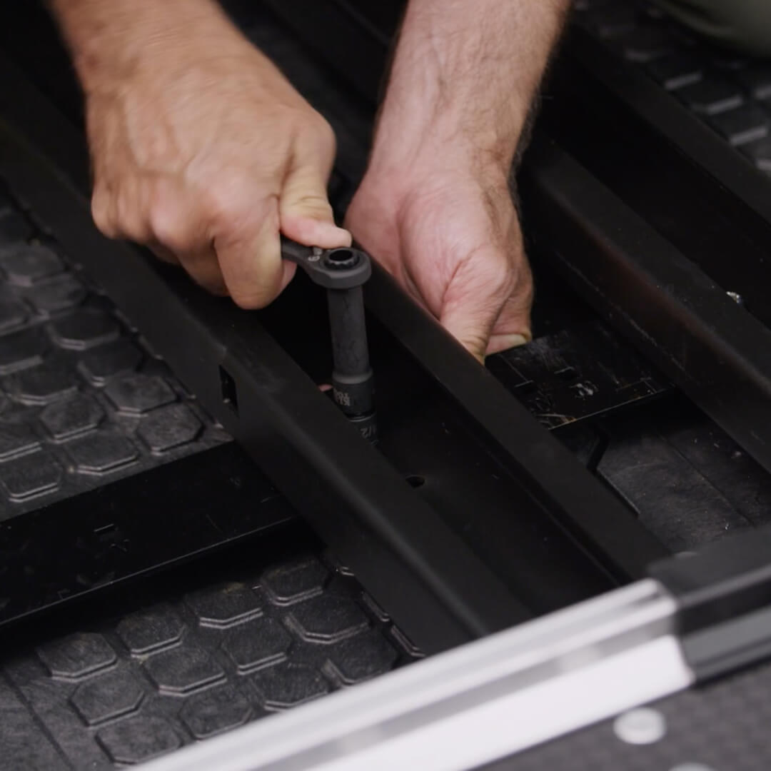 A close up of someone tightening the Mounting Brackets to a Drawer System.