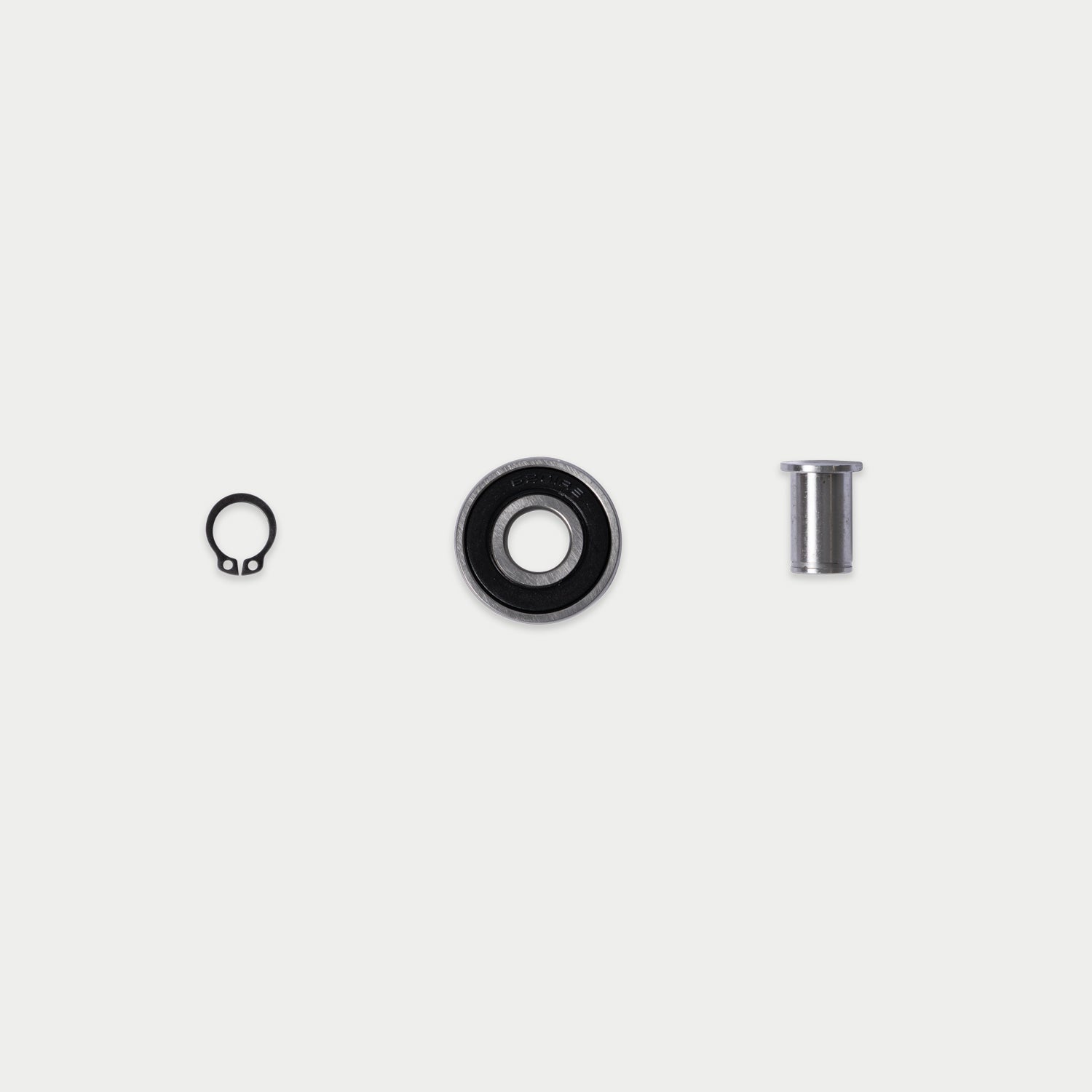 [RCG005] CargoGlide bearing, axle, and c-clip on light grey background.
