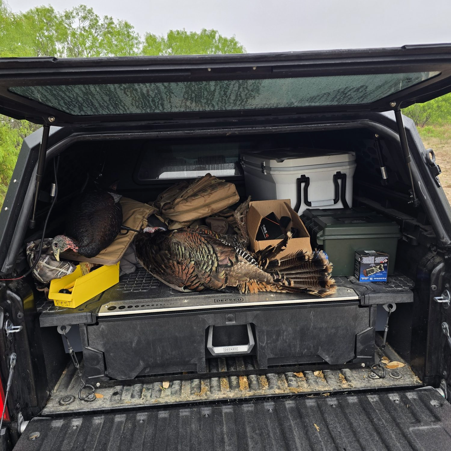 Shooting News Weekly highlights a DECKED drawer system as part of a highly functional truck setup paired with the OPENROAD 4WD truck cap.
