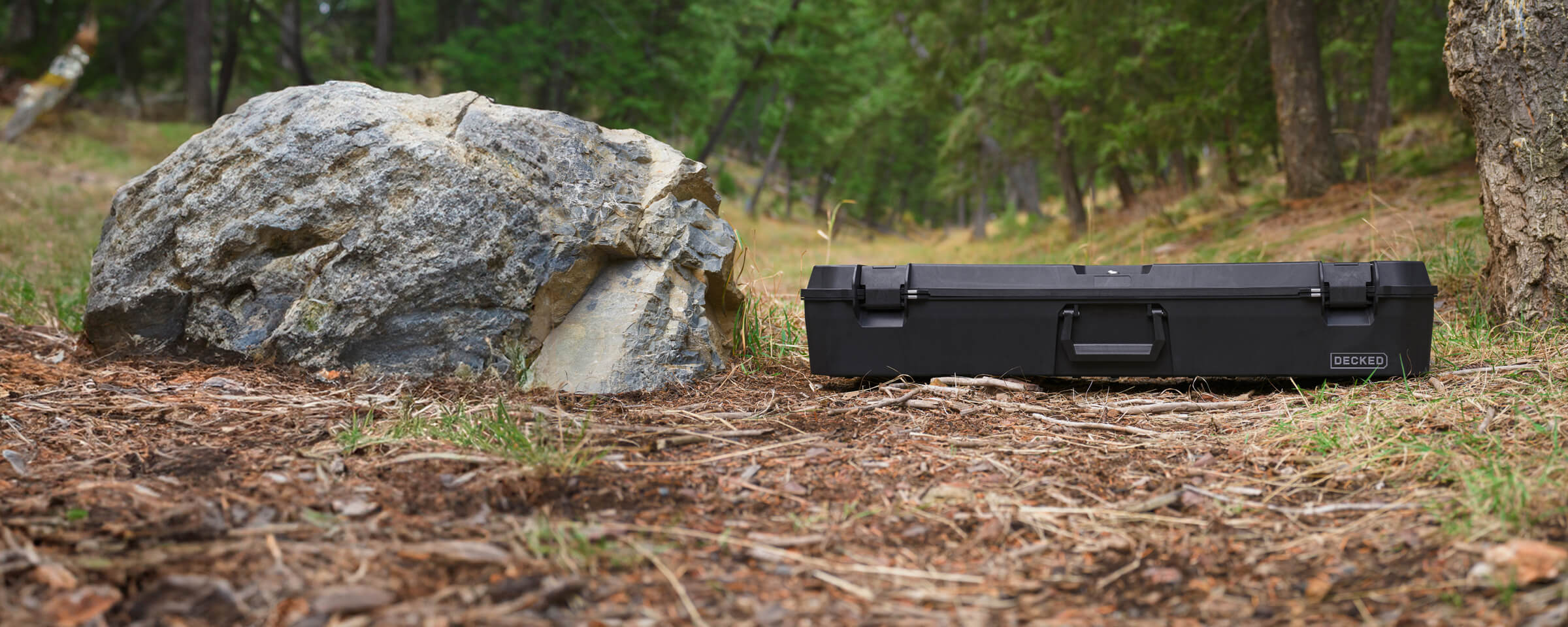 The Black Honcho sitting on the ground at a DECKED'ers campsite in Idaho.