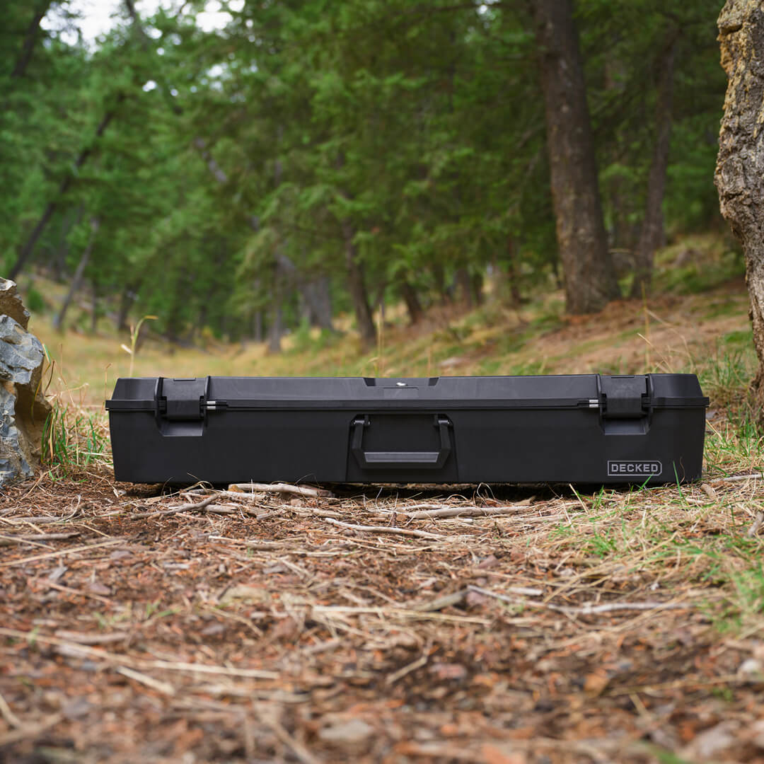 The Black Honcho sitting on the ground at a DECKED'ers campsite in Idaho.