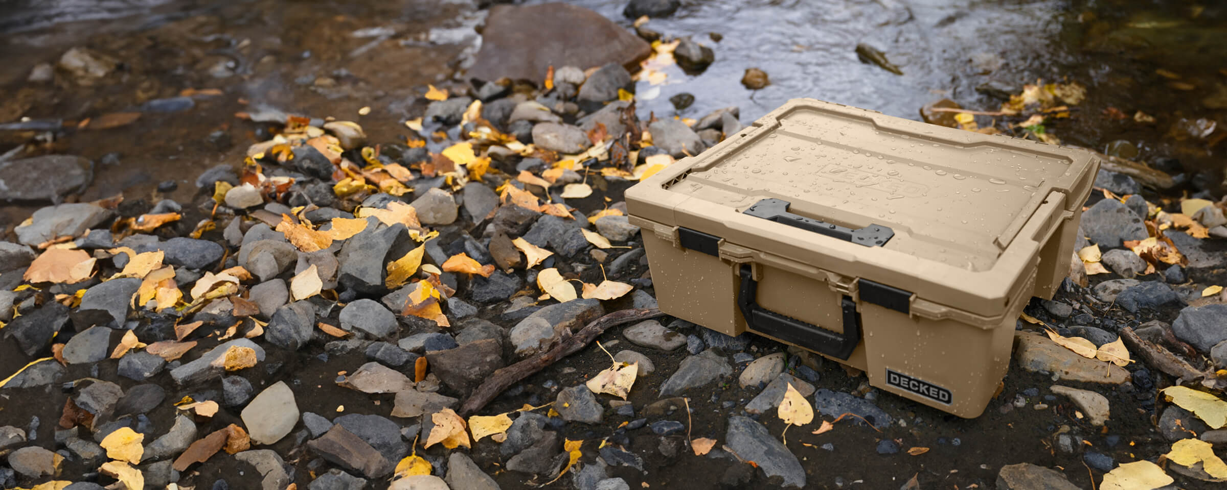 A Desert Tan Halfrack sitting riverside, the D-co Case has been splashed with water but its owner can feel comfort that its contents are safe and dry.