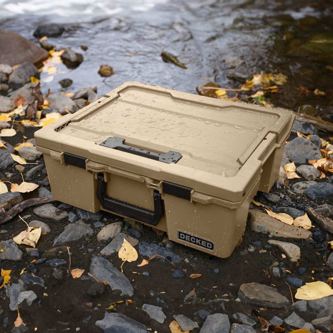 A Desert Tan Halfrack sitting riverside, the D-co Case has been splashed with water but its owner can feel comfort that its contents are safe and dry.