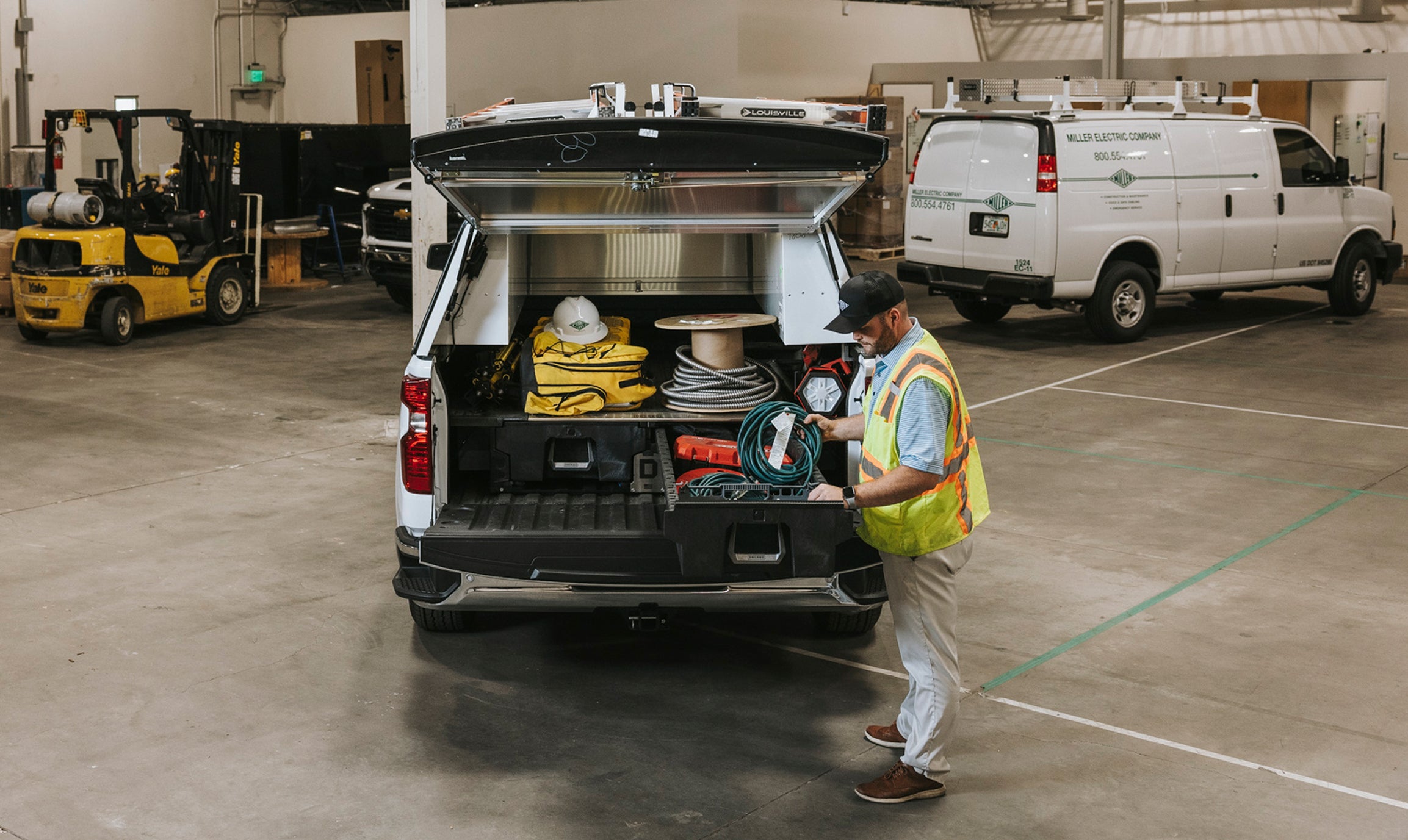 Electrician storing gear and cords inside hid DECKED drawer system at the jobsite.
