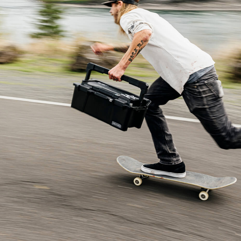 DECKED ambassador, David Gravette, holding tight to his Black Sixer D-co Case while flying down the street on his skateboard.