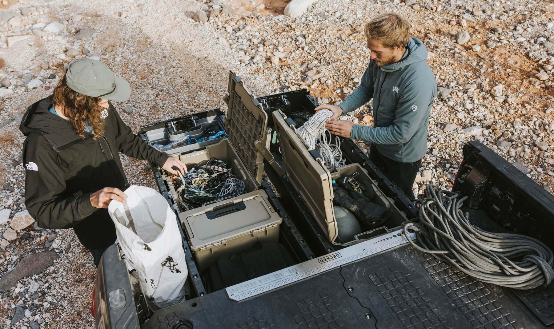 DECKED ambassador, Jackson Marvell, using his Desert Tan D-co Cases in his Drawer System to keep all of his climbing gear safe, dry, and organized so he is always ready to get after it.