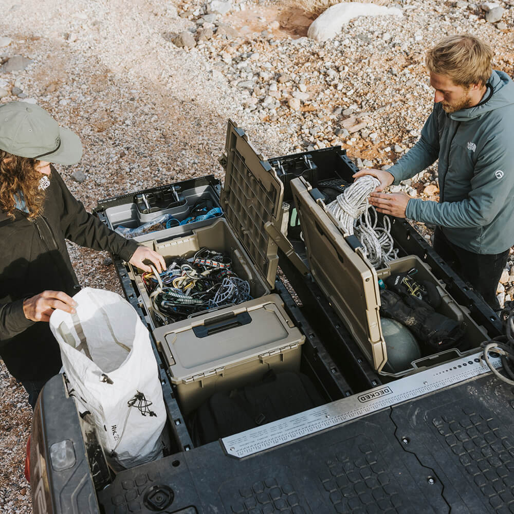 DECKED ambassador, Jackson Marvell, using his Desert Tan D-co Cases in his Drawer System to keep all of his climbing gear safe, dry, and organized so he is always ready to get after it.