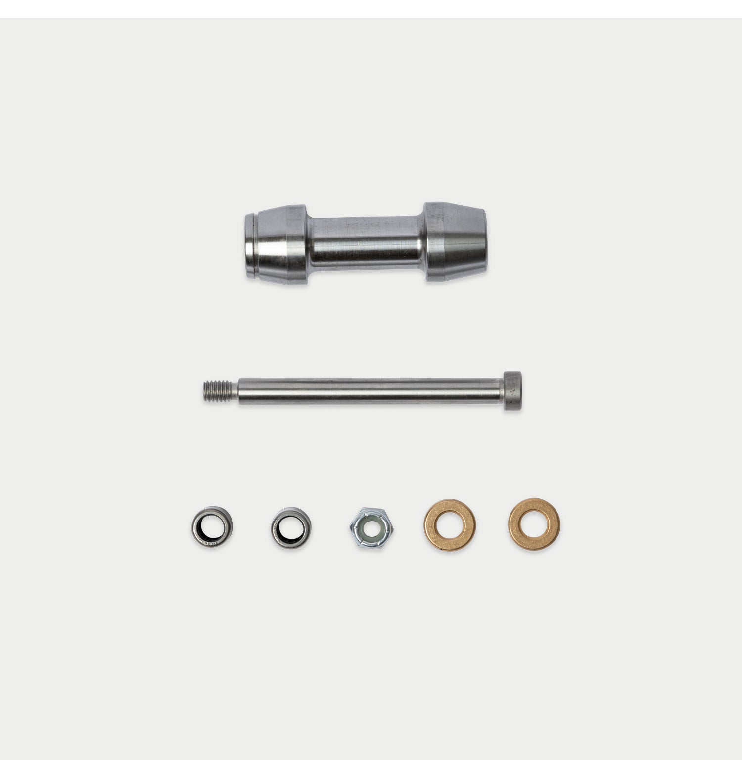 [W-DCG-600/1000-TG-ROLLER-KIT-DS-ROLLER] A metal hardware kit containing a cylindrical metal sleeve, a threaded metal rod, a silver hex nut, and two flat washers in silver and bronze, arranged on a light gray background.