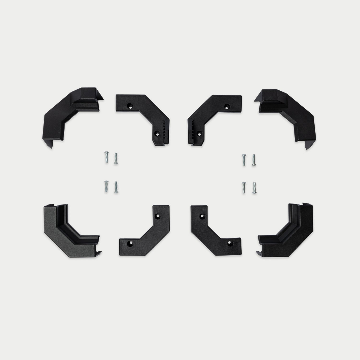 [W-DCG-ALL-CORNERS-KIT] Eight black metal mounting brackets arranged, with eight small silver screws in the center, on a light gray background.