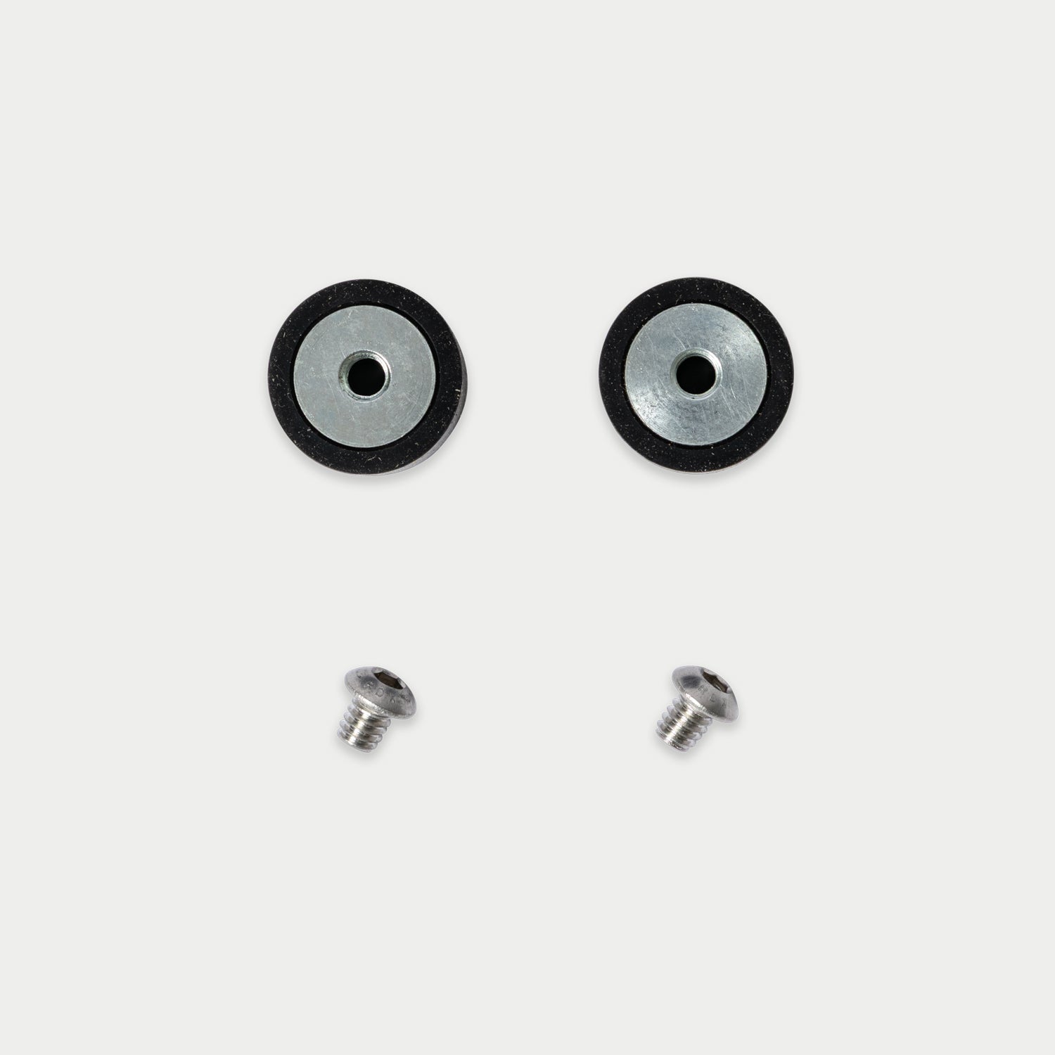 [W-DCG-BUMPER-KIT] Two circular black and silver hardware pieces with two small silver screws, arranged on a light gray background.
