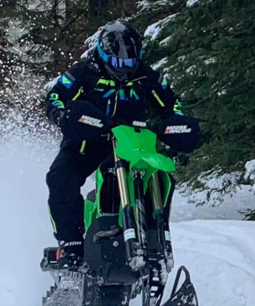 Calvin brapping on a snowbike.