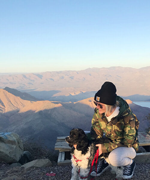 Woman posing next to her dog