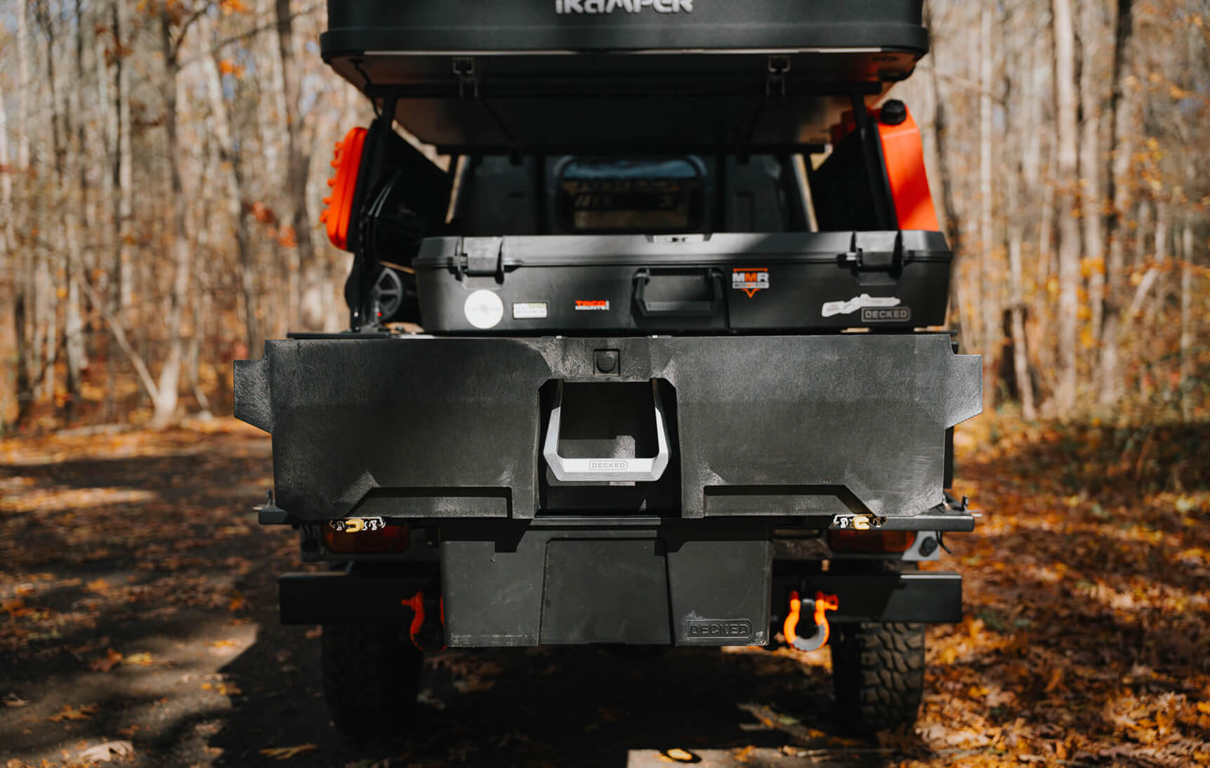 Back of a vehicle with a cargo carrier in a forest setting