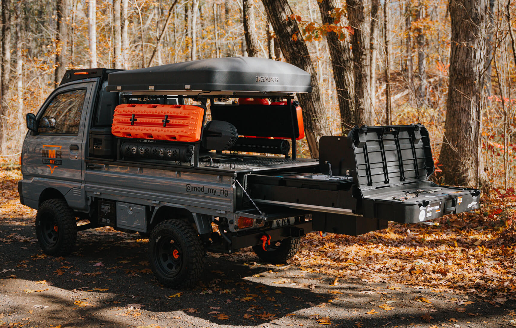 Truck with open cargo bed in a forest setting