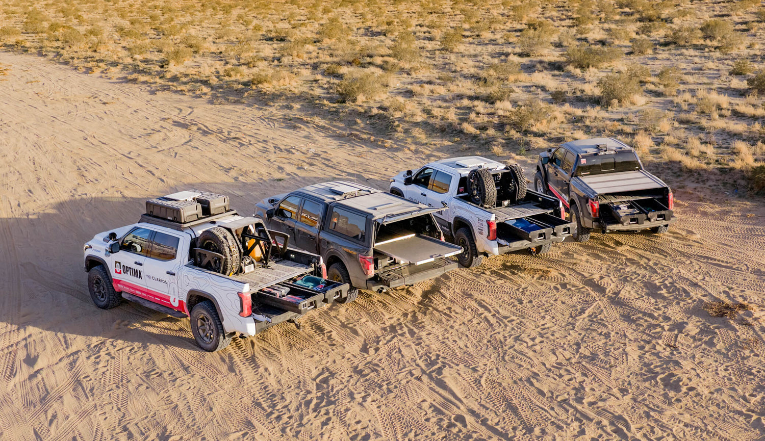 A wide shot of the Optima truck fleet that are each equipped with a DECKED Drawer System or CargoGlide that maximizes the usable space in the truck bed.