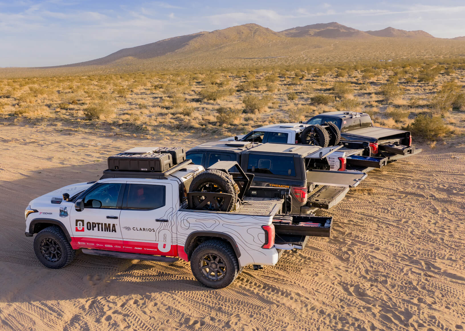 The four optima fleet trucks that are varying sizes, colors, wraps and have different DECKED Drawer System and CargoGlide systems in each bed.