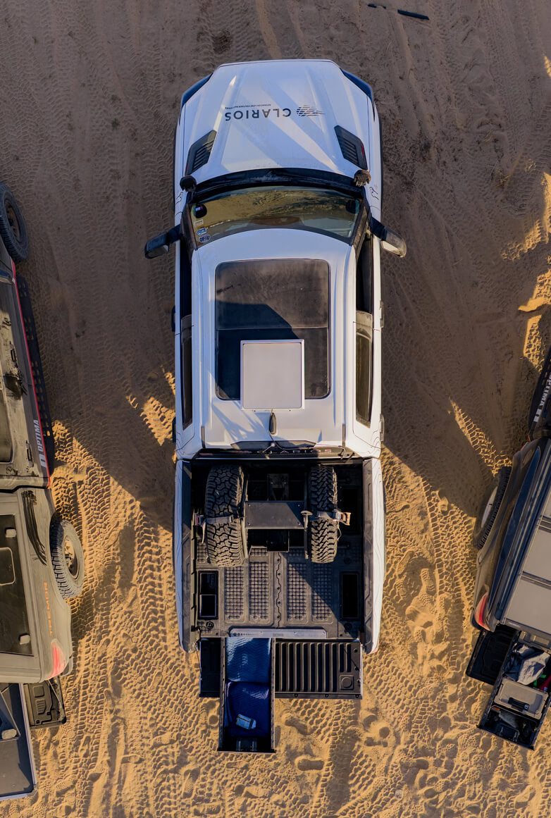 A bird's eye view of one of the Optima fleet trucks that has a Drawer System and several spare tires in the truck bed.