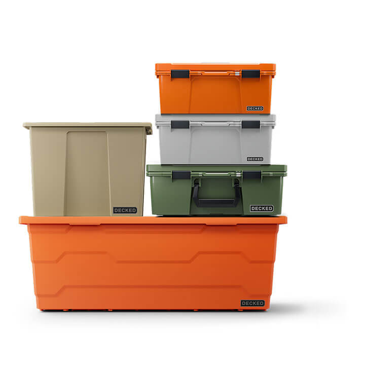 Stack of orange, gray, and green DECKED storage bins and protective cases on a white background