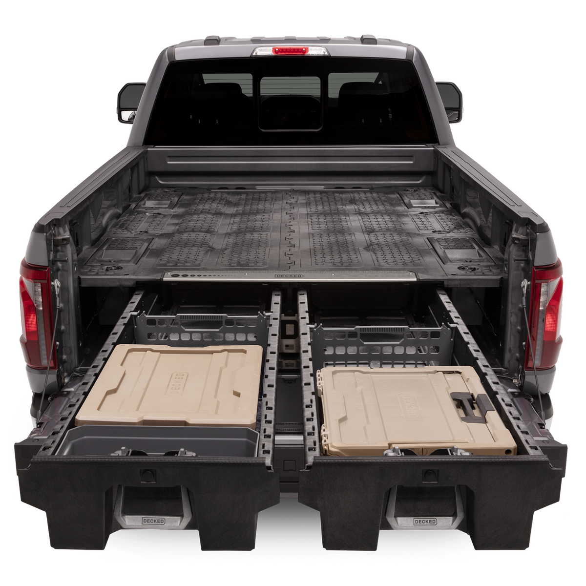 An open drawer system with 'DECKED' d-co cases and other storage options in the bed of a Ford F-150.
