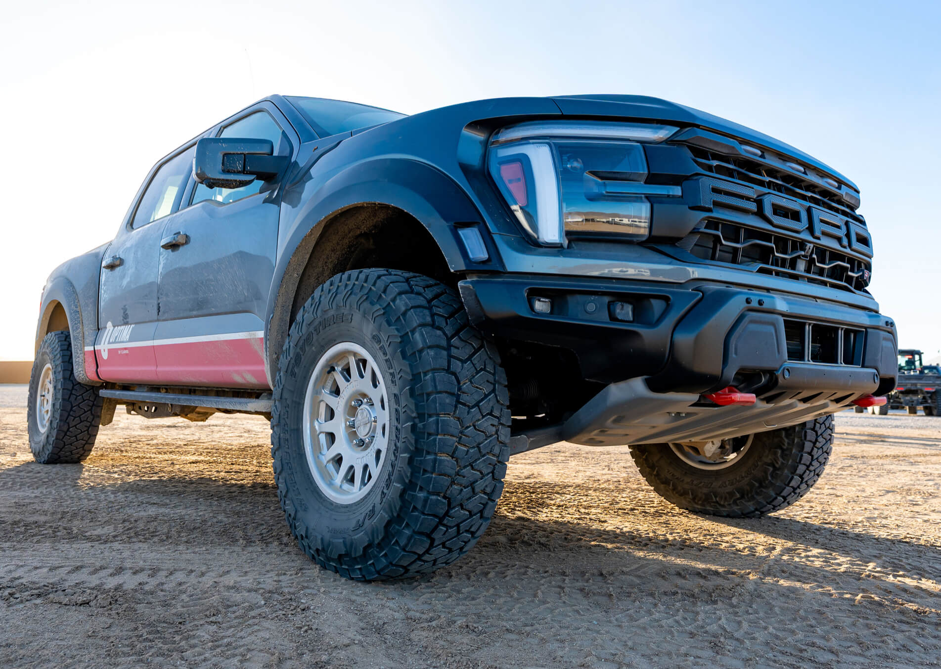 Pickup truck on a dirt road with a clear sky