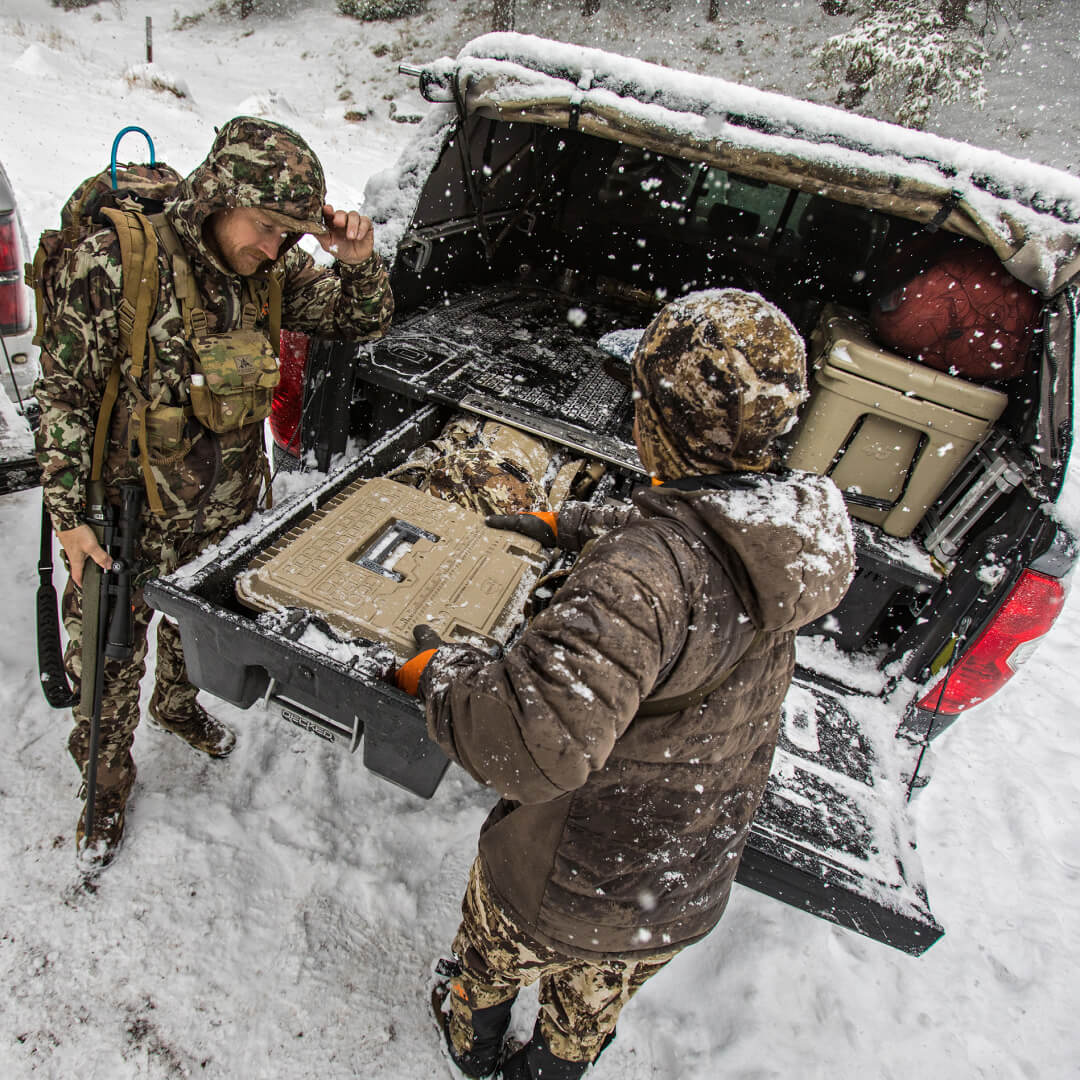 Hunters grabbing a Tan D-box out of a Drawer System in the snow