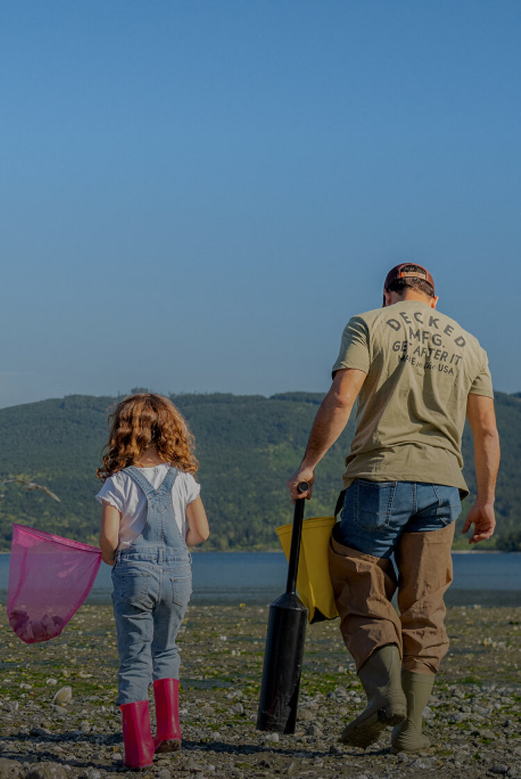 A DECKED Dad walking the beach, enjoying his time off with his little girl, collecting sea shells in pink butterfly nets.