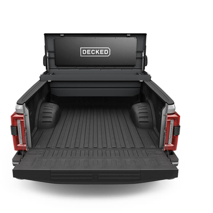 An open black Tool Box in the bed of a Ford F-350.