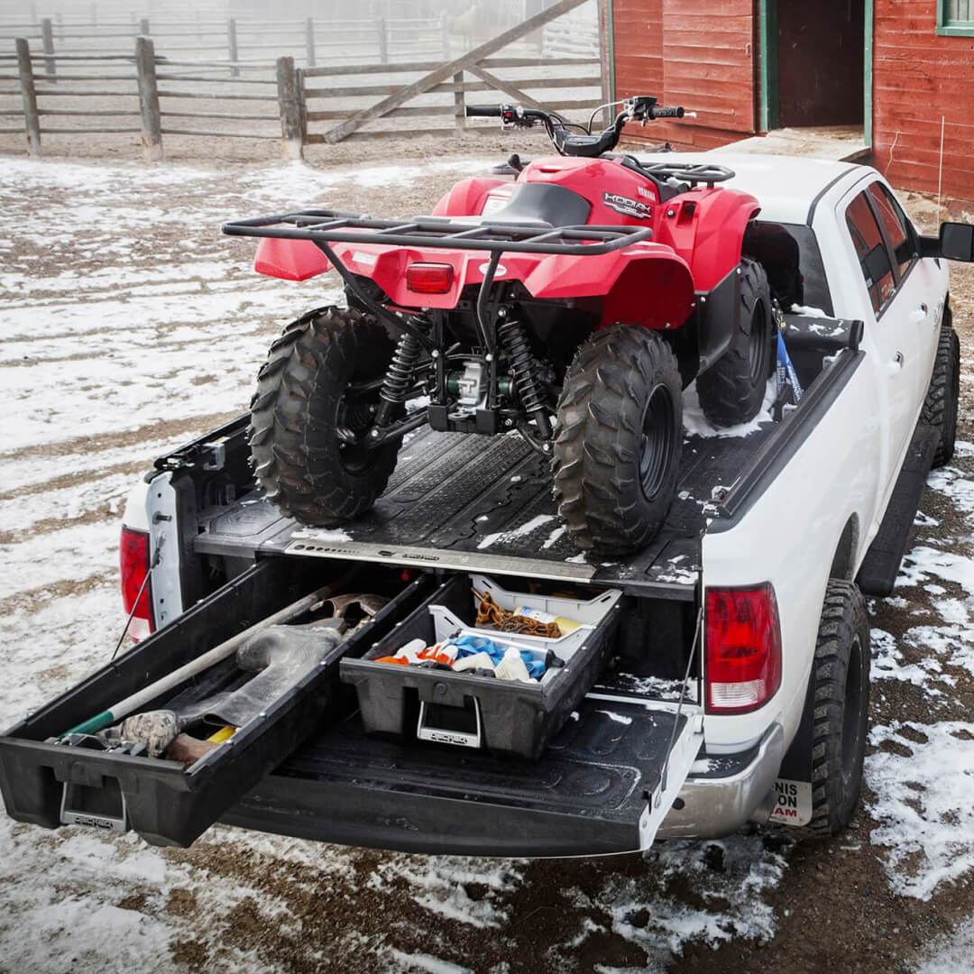 Drawer System installed in the back of a truck with an ATV on top