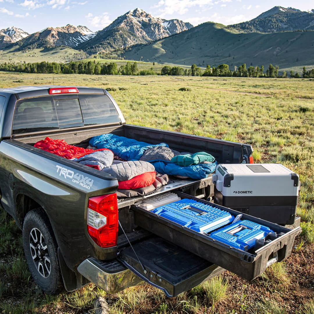 Drawer System inside a full-size truck being used as a sleeping platform in the mountains