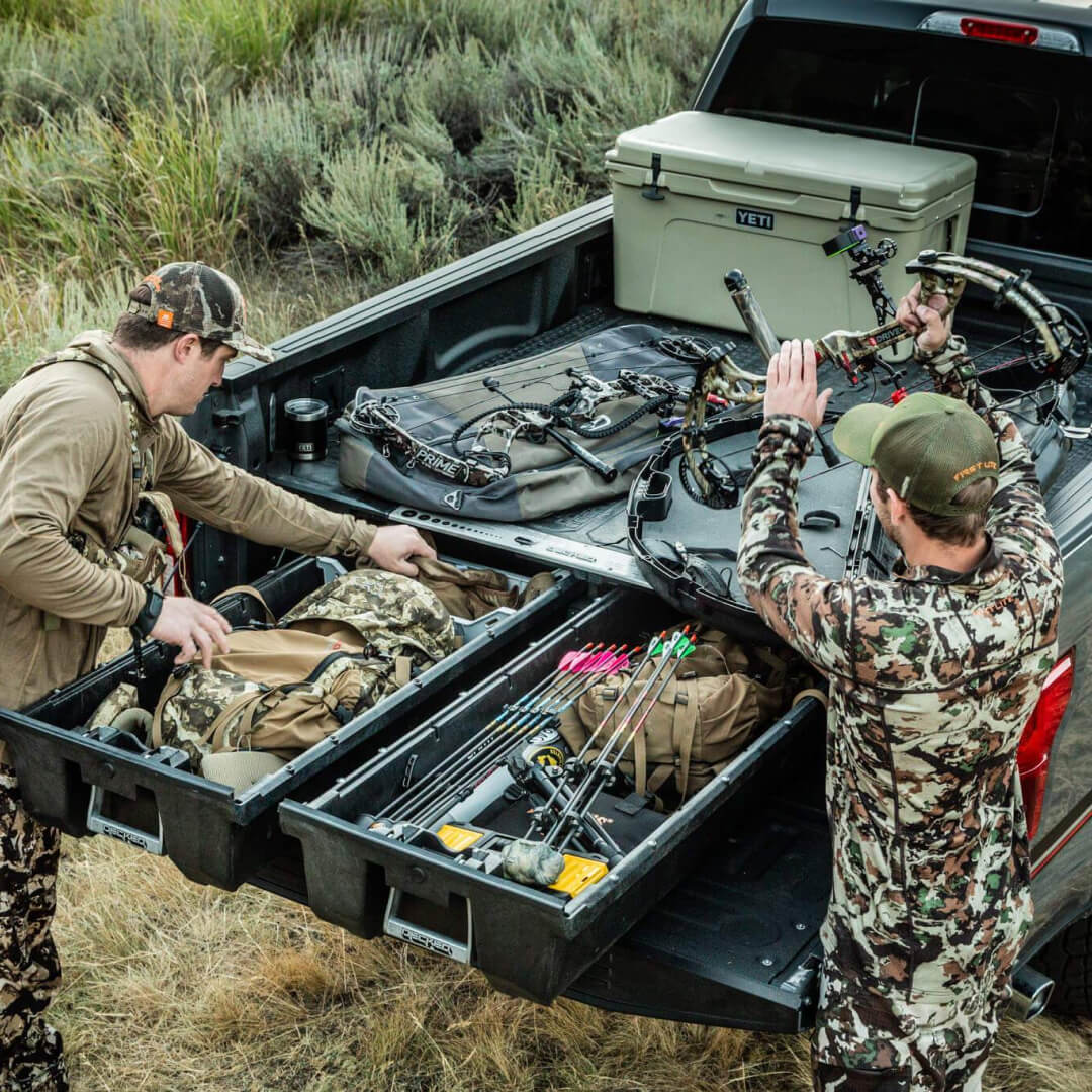 Two hunters grabbing their hunting gear out of a Drawer System