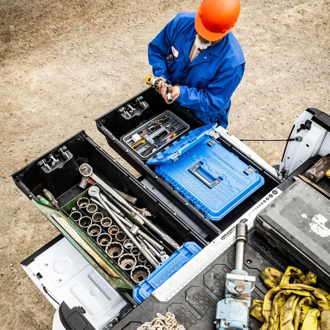 Overhead view of a construction worker grabbing a drill out of his Drawer System