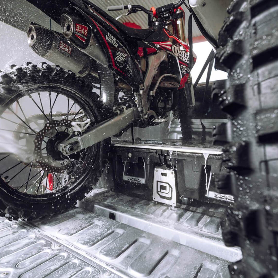 Dirt bike on top of a Drawer System being sprayed down at a car wash